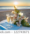 Flowers and champagne glasses on a seaside table 122743671