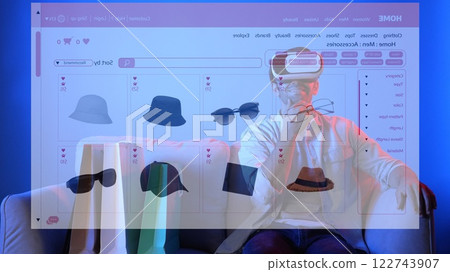 Man sitting at sofa by using VR glasses and shopping online platform. Apparatus. Man sitting at sofa by using VR glasses and shopping online platform. Apparatus. 122743907
