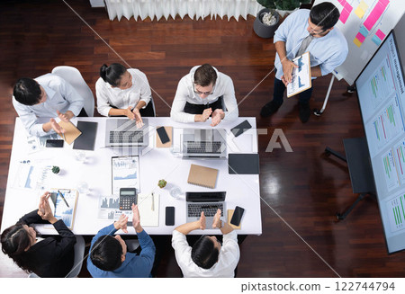 Analyst team utilizing BI Fintech to analyze financial data at table. Prudent 122744794