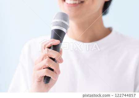 Image of a man's hand holding a microphone (stock photo) 122744857