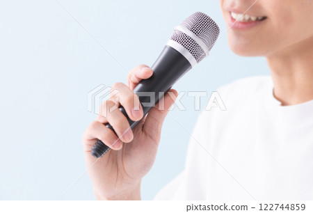 Image of a man's hand holding a microphone (stock photo) Image of a man's hand holding a microphone (stock photo) 122744859