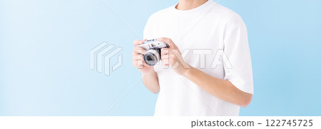 Image of a man holding a camera (stock photo) 122745725