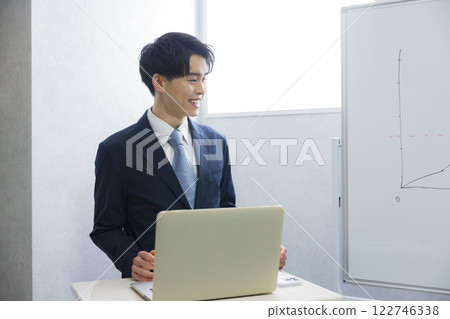 Young businessman presenting Young businessman presenting 122746338