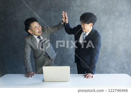 A smiling businessman doing a guts pose A smiling businessman doing a guts pose 122746466