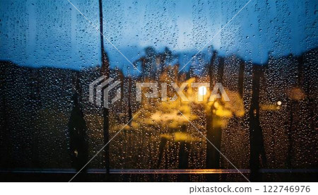Background material of water droplets and raindrops on a glass window in the rain in the evening 122746976