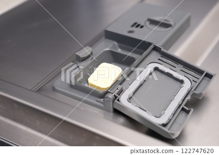 Girl cleaning dishwasher in kitchen Girl cleaning dishwasher in kitchen 122747620