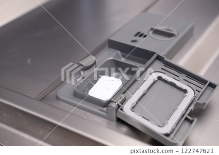 Girl cleaning dishwasher in kitchen Girl cleaning dishwasher in kitchen 122747621