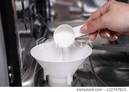 Girl cleaning dishwasher in kitchen 122747623