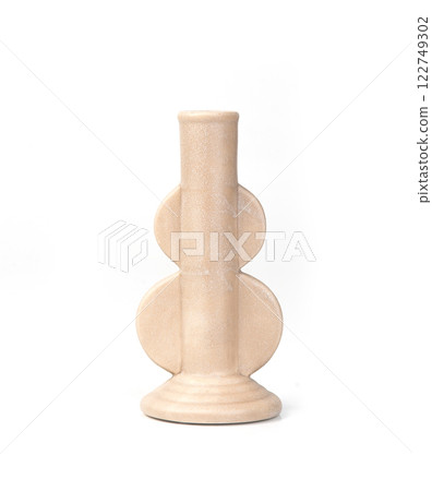 Modern ceramic candle holder with a geometric design in matte beige. A stylish and minimalist decor 122749302