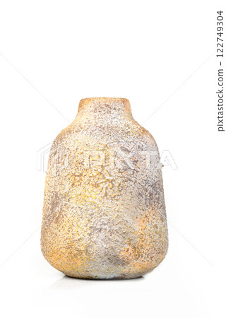 Rustic ceramic vase with a rough textured surface and earthy tones, isolated on a white background. 122749304