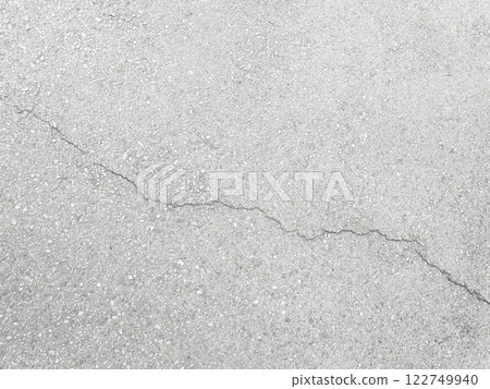 A horizontal background image of white-gray asphalt with diagonal cracks 1 122749940