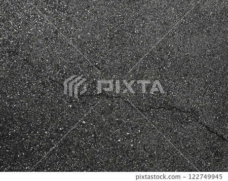 Horizontal background image of black-gray asphalt with diagonal cracks 1 122749945