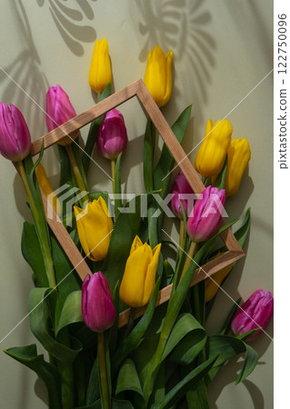 Bouquet of colorful tulips with creative photo frame in pastel green background. Copy space for greeting card. Holiday flowers springtime 122750096