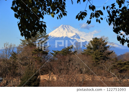 Snow capped Mount Fuji against a blue sky as seen from Shuzenji on the Izu peninsula in Shizuoka Japan Snow capped Mount Fuji against a blue sky as seen from Shuzenji on the Izu peninsula in Shizuoka Japan 122751093