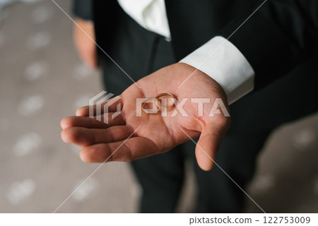 Groom Holding Wedding Rings In Hand 122753009
