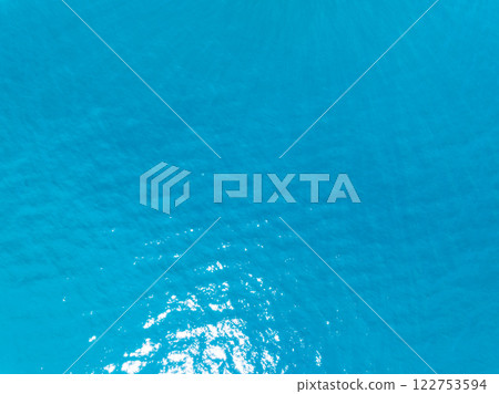 Aerial view of blue sea surface water texture background,Sun reflections on water, Aerial flying drone view Waves water surface texture on sunny tropical ocean in Phuket island Thailand Aerial view of blue sea surface water texture background,Sun reflections on water, Aerial flying drone view Waves water surface texture on sunny tropical ocean in Phuket island Thailand 122753594