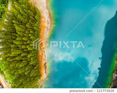 Aerial view of amazing pond in tropical rainforest with mountain rocks peak, Beautiful water surface in Phang Nga Thailand Aerial view of amazing pond in tropical rainforest with mountain rocks peak, Beautiful water surface in Phang Nga Thailand 122753626