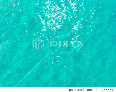 Aerial view of blue sea surface water texture background,Sun reflections on water, Aerial flying drone view Waves water surface texture on sunny tropical ocean in Phuket island Thailand Aerial view of blue sea surface water texture background,Sun reflections on water, Aerial flying drone view Waves water surface texture on sunny tropical ocean in Phuket island Thailand 122753634