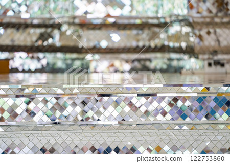 Buddhist Temple pillars and bas of pillars are decorated with Mosaic mirror. Traditional Thai temple pillar decorated with beautiful mosaic pattern inside the Buddhist temple. 122753860