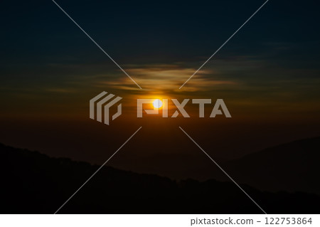 The beautiful sunrise at Doi intanon national park, Chiang Mai in the morning.Sun is rising from the hill to shy with beautiful yellow orange light. 122753864