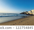 Coastline of Praia das Mação with the light of the setting sun reflecting off the coast 122754845