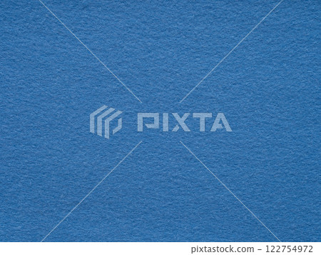 A serene expanse of textured blue felt creates a calm, minimalist backdrop 122754972