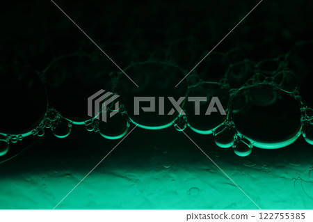 Green liquid surface, fantastic bubbles connections, fluid movement, dark fantastic background, transparent forms, black and green Green liquid surface, fantastic bubbles connections, fluid movement, dark fantastic background, transparent forms, black and green 122755385
