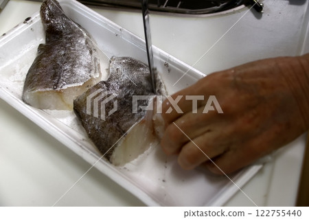 A housewife cutting up a cod fish A housewife cutting up a cod fish 122755440