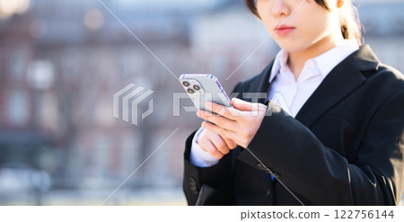 A young woman looking for a job walking through an office district 122756144