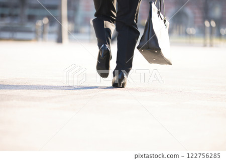 Back view of a young woman running through an office district Back view of a young woman running through an office district 122756285