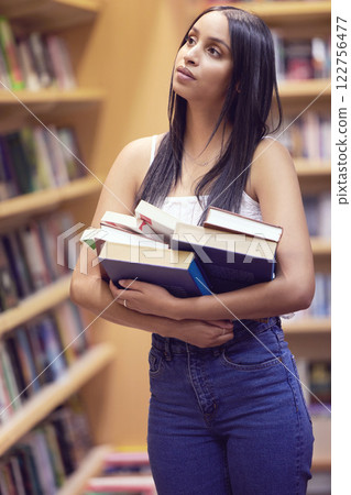Library, education or university and a woman student looking for books or study material in a bookstore. College, scholarship or literature with a young female on campus searching for a reading novel 122756477