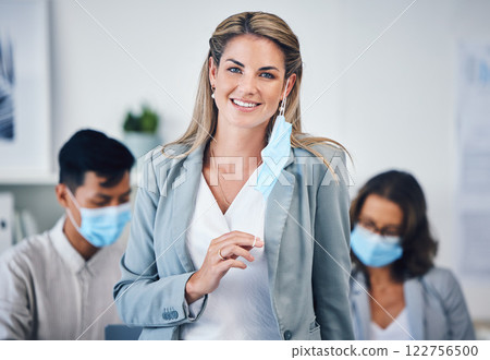 Portrait of a business woman in her office with a face mask and her team during covid pandemic. Corporate, creative and professional manager working on a group project in the company conference room. Portrait of a business woman in her office with a face mask and her team during covid pandemic. Corporate, creative and professional manager working on a group project in the company conference room. 122756500