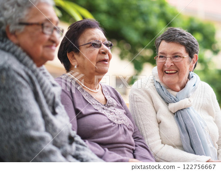 Outdoor, friends and bench with old women, conversation and bonding together with retirement, park and cheerful. Ladies, outside and elderly people with humor, senior group and weekend break with joy 122756667