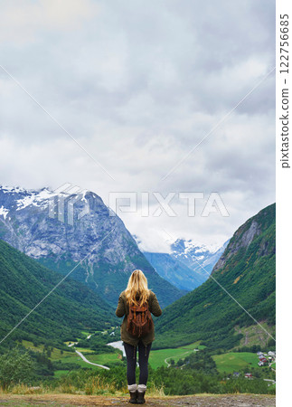Travel adventure woman enjoying view of majestic glacial valley on exploration discover beautiful earth 122756685