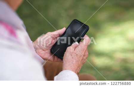 Person, hands and smartphone for communication, phone screen and online conversation in garden. Cellphone, social media and mobile application or website, internet connection and research on mockup 122756880