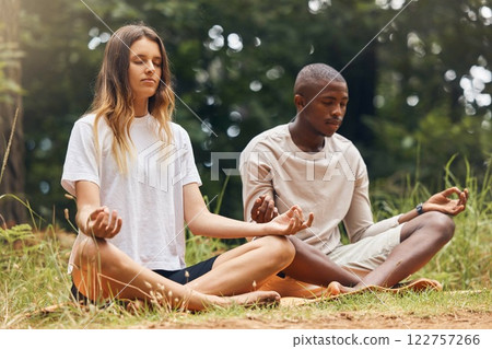 Yoga, interracial couple and meditation for zen and balance with black man and white woman sitting in lotus at a park in nature. Calm and content with holistic spiritual exercise and health training 122757266