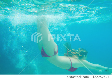 Woman, swimming and ocean in bikini adventure for underwater fun, explore on summer vacation. Female person, island and discover journey on holiday for sea travel, exotic diving on paradise trip Woman, swimming and ocean in bikini adventure for underwater fun, explore on summer vacation. Female person, island and discover journey on holiday for sea travel, exotic diving on paradise trip 122757425