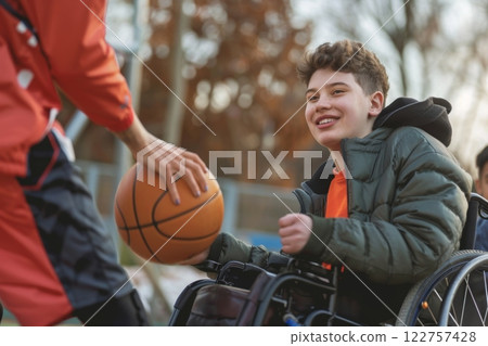 Empowered Youth in Wheelchairs Actively Engaging in Enjoyable Basketball Play and Building Relationships 122757428