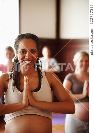 Wellness, yoga and meditation of pregnant friends or women with spiritual, health and healthy lifestyle with prayer hands sign. Portrait of happy mother to be in yoga class with smile in a zen studio Wellness, yoga and meditation of pregnant friends or women with spiritual, health and healthy lifestyle with prayer hands sign. Portrait of happy mother to be in yoga class with smile in a zen studio 122757555
