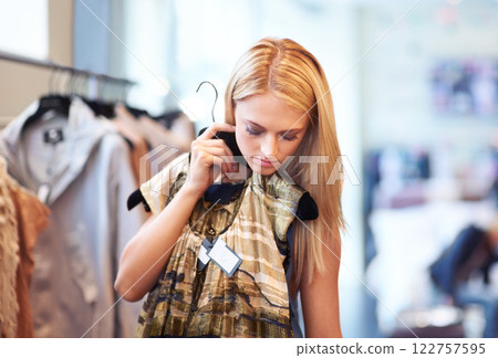 Shopping, retail and fashion for a customer or woman choosing a dress at a clothing store at the mall. Young female spending money at a boutique buying clothes at a shop or outlet Shopping, retail and fashion for a customer or woman choosing a dress at a clothing store at the mall. Young female spending money at a boutique buying clothes at a shop or outlet 122757595
