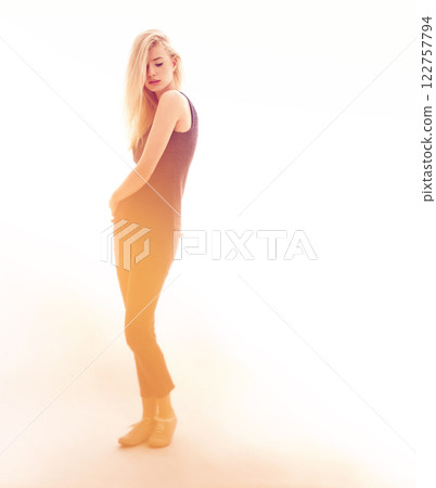 Fashion, model and beauty with a sexy woman in studio on a creative and white background. Young female posing in modern and elegant clothes, looking confident, proud and beautiful on sensual lighting 122757794