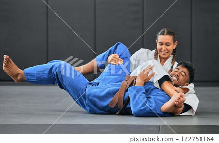 Karate, judo and aikido fighters fighting to win in martial arts fight competition to train or practice skills. Winning competitive female or athlete in match with submission self defense technique Karate, judo and aikido fighters fighting to win in martial arts fight competition to train or practice skills. Winning competitive female or athlete in match with submission self defense technique 122758164