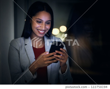 Social media, contact us and phone with a business woman working in a dark office and reading an email on her mobile. Corporate professional closing a global deal across an international time zone 122758194