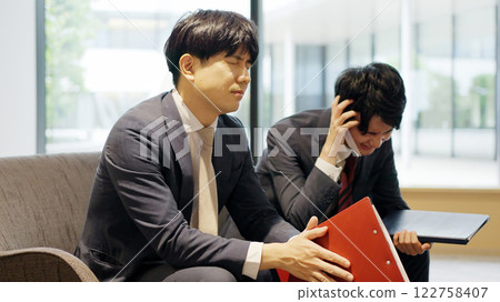 A businessman who is depressed at work 122758407