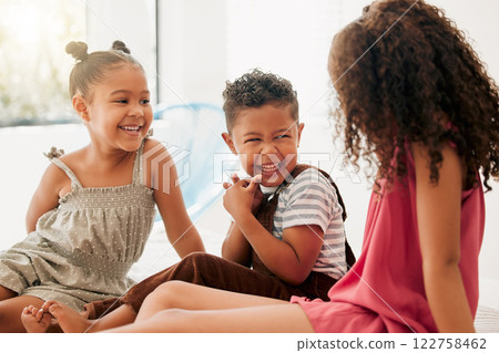 Happy, cheerful and laughing children sitting together and having fun at a playdate. Adorable boy and girls enjoying their time together at home. Siblings, sisters and brother bonding and playing 122758462