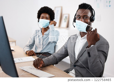 Customer service workers with protection from covid, mask and good hygiene. Online, call center or IT hotline support employees with headset, social distancing in corona virus pandemic or lockdown 122758465