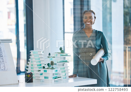 Architect, engineer and designer holding a blueprint with a positive mindset, mission and vision in an office. Portrait of a black woman standing next to 3D representation of proposed building design Architect, engineer and designer holding a blueprint with a positive mindset, mission and vision in an office. Portrait of a black woman standing next to 3D representation of proposed building design 122758493