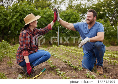 Teamwork, agriculture and collaboration high five farmer couple planting organic crops while bonding. Sustainability farm partners excited to go green and begin new business with fresh vegetables Teamwork, agriculture and collaboration high five farmer couple planting organic crops while bonding. Sustainability farm partners excited to go green and begin new business with fresh vegetables 122758505
