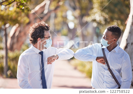 Covid greet, social distancing and elbow bump by business men meeting and greeting outdoors. Happy, friendly and excited colleagues using covid19 prevention protocol and wearing masks Covid greet, social distancing and elbow bump by business men meeting and greeting outdoors. Happy, friendly and excited colleagues using covid19 prevention protocol and wearing masks 122758522