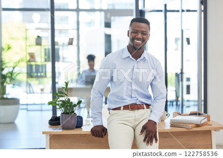 Smiling, motivated and ambitious business man feeling excited about a new job opportunity in creative office. Portrait of confident and inspired marketing agent with vision, growth mindset and ideas 122758536